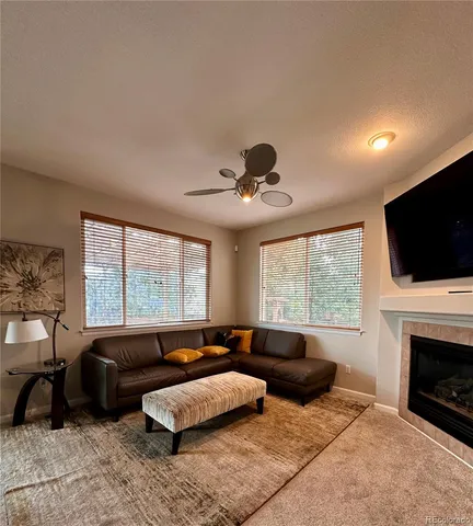 a living room with furniture flat screen tv and a fireplace