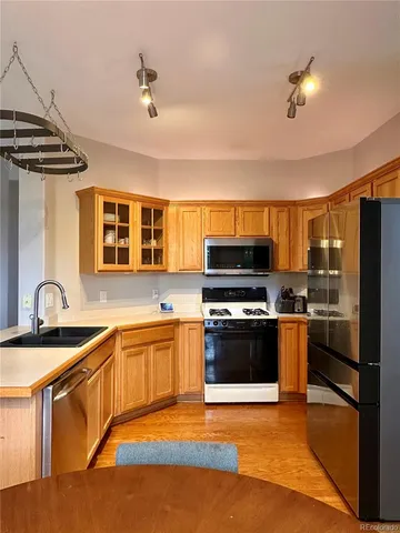 a kitchen with stainless steel appliances granite countertop a stove and a sink