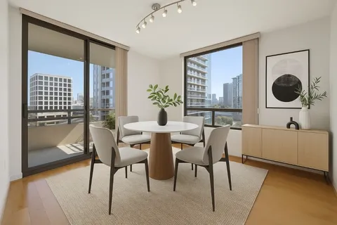 a view of a dining room with furniture and window