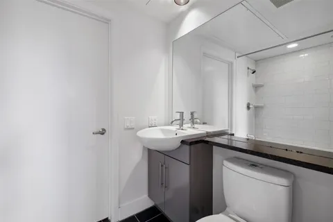a utility room with a sink and a mirror