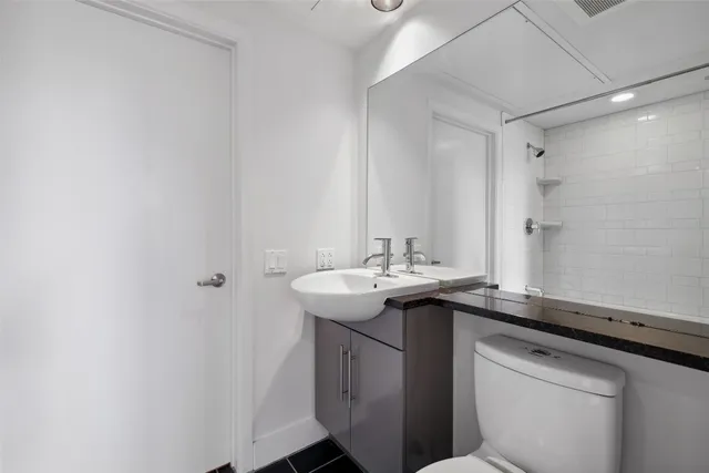 a utility room with a sink and a mirror