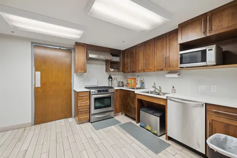 a kitchen with stainless steel appliances granite countertop a stove and a sink