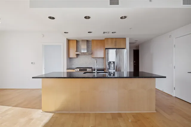 a large white kitchen with granite countertop a sink