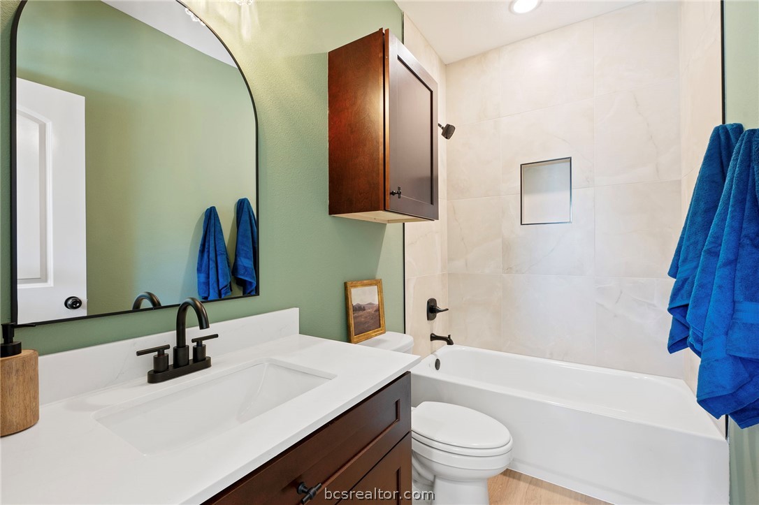 106 33rd Street West Bryan, TX 77803 - Photo 15 of 22 a bathroom with a sink and a mirror