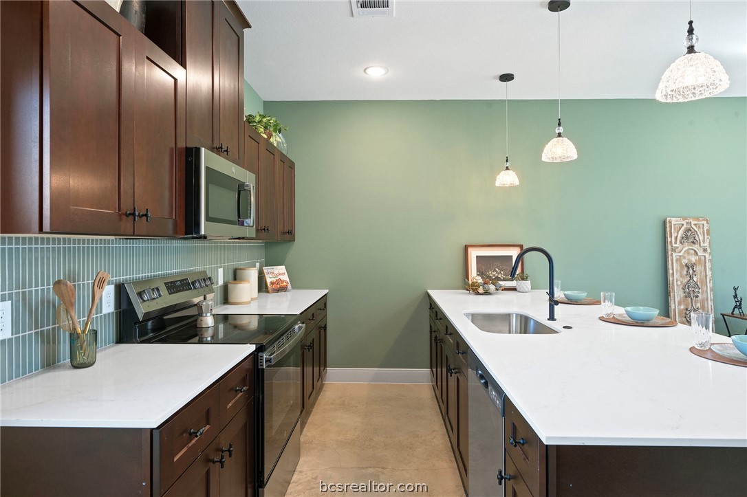 106 33rd Street West Bryan, TX 77803 - Photo 2 of 22 a kitchen that has a sink and a stove