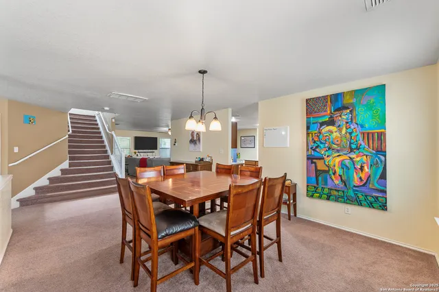 a dining room with furniture and a rug
