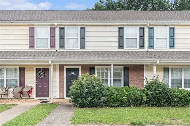 a front view of a house with garden and porch