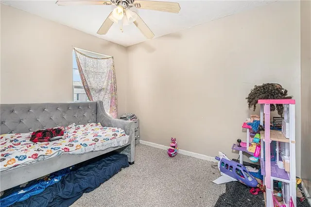 a bedroom with bed and a chandelier