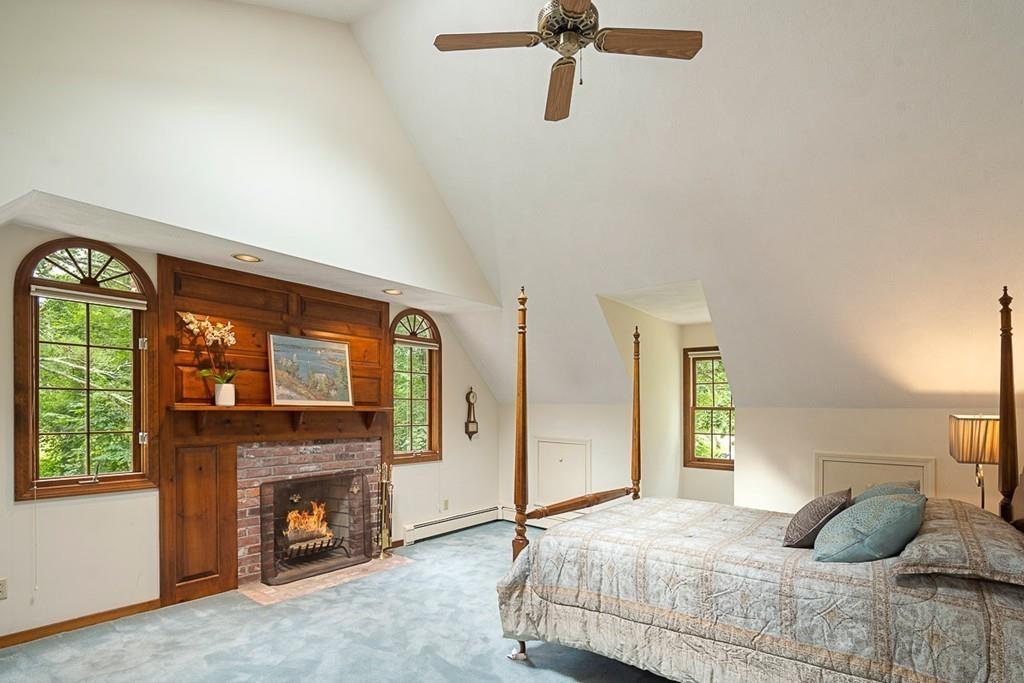 206 Prospect Street Carlisle, MA 01741 - Photo 15 of 25 a bedroom with a bed and a fireplace