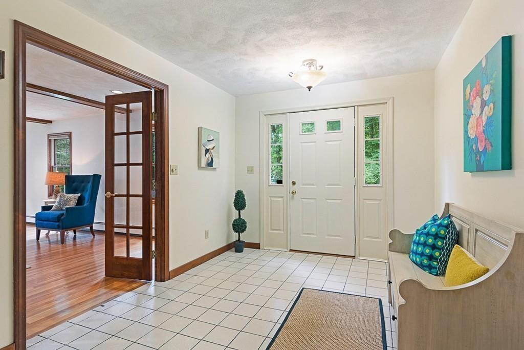 206 Prospect Street Carlisle, MA 01741 - Photo 3 of 25 a view of an entryway with wooden floor and a potted plant
