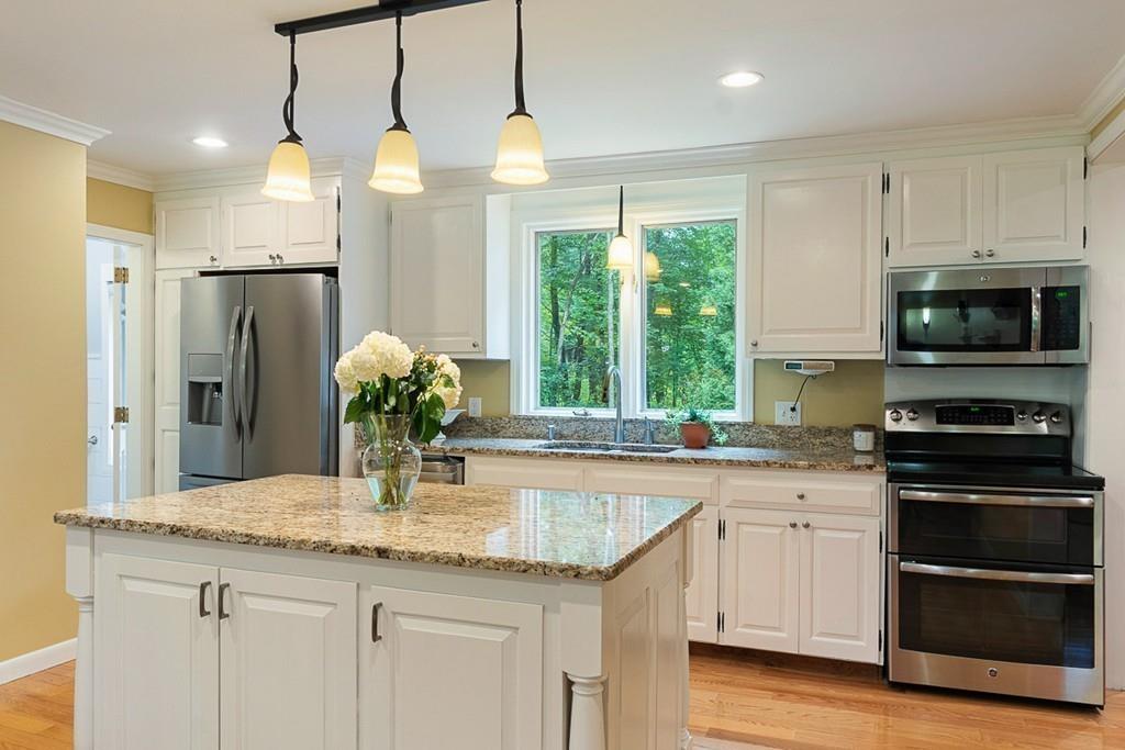 206 Prospect Street Carlisle, MA 01741 - Photo 5 of 25 a kitchen with stainless steel appliances granite countertop a sink a stove a refrigerator and cabinets