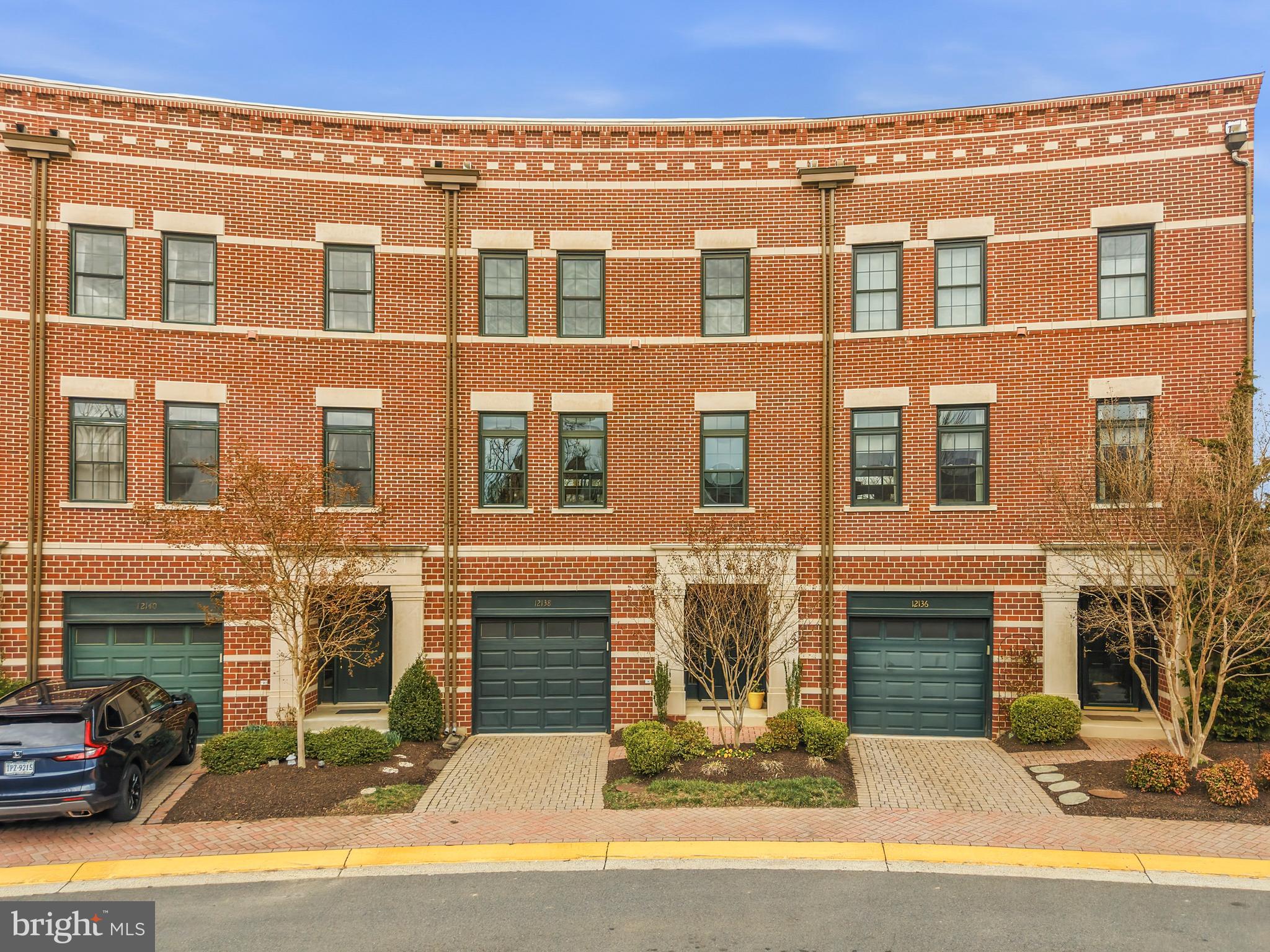 12138 Chancery Station Circle Reston, VA 20190 - Photo 1 of 54 a front view of a building with parking area