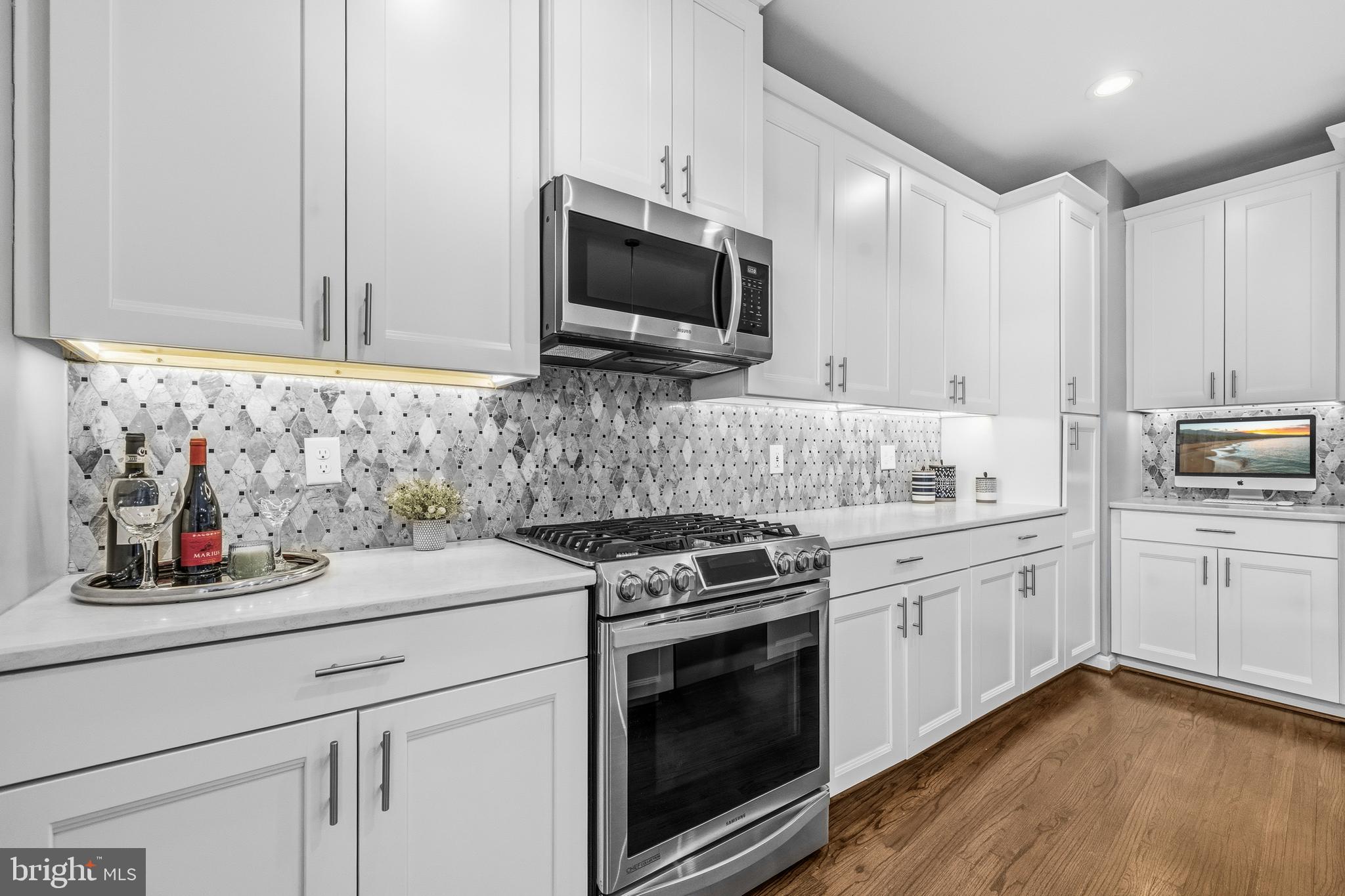 12138 Chancery Station Circle Reston, VA 20190 - Photo 14 of 54 a kitchen with stainless steel appliances granite countertop a sink and a stove