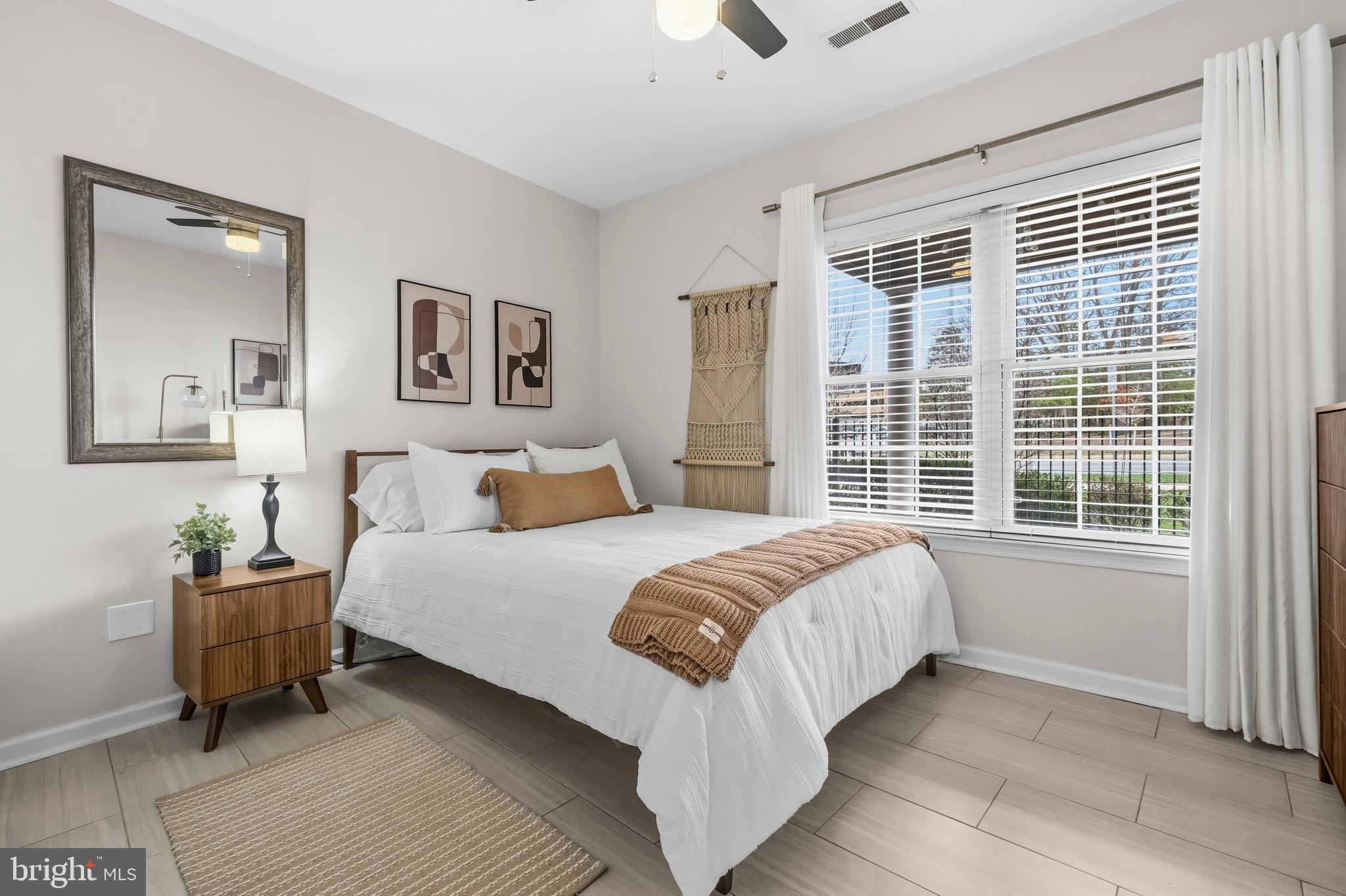12138 Chancery Station Circle Reston, VA 20190 - Photo 17 of 54 a bedroom with a large bed and a window