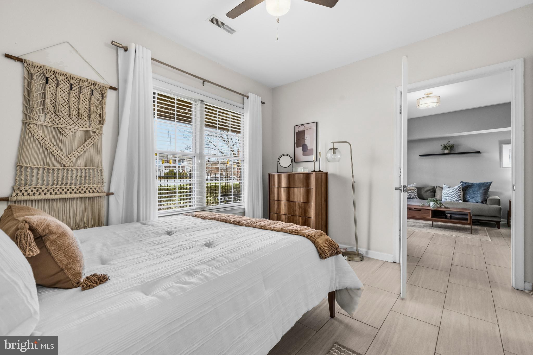 12138 Chancery Station Circle Reston, VA 20190 - Photo 18 of 54 a bedroom with a bed and a large window