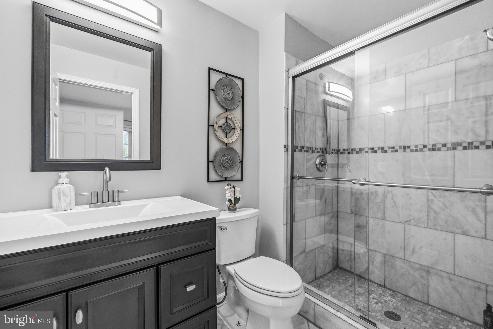 12138 Chancery Station Circle Reston, VA 20190 - Photo 19 of 54 a bathroom with a sink a toilet and shower