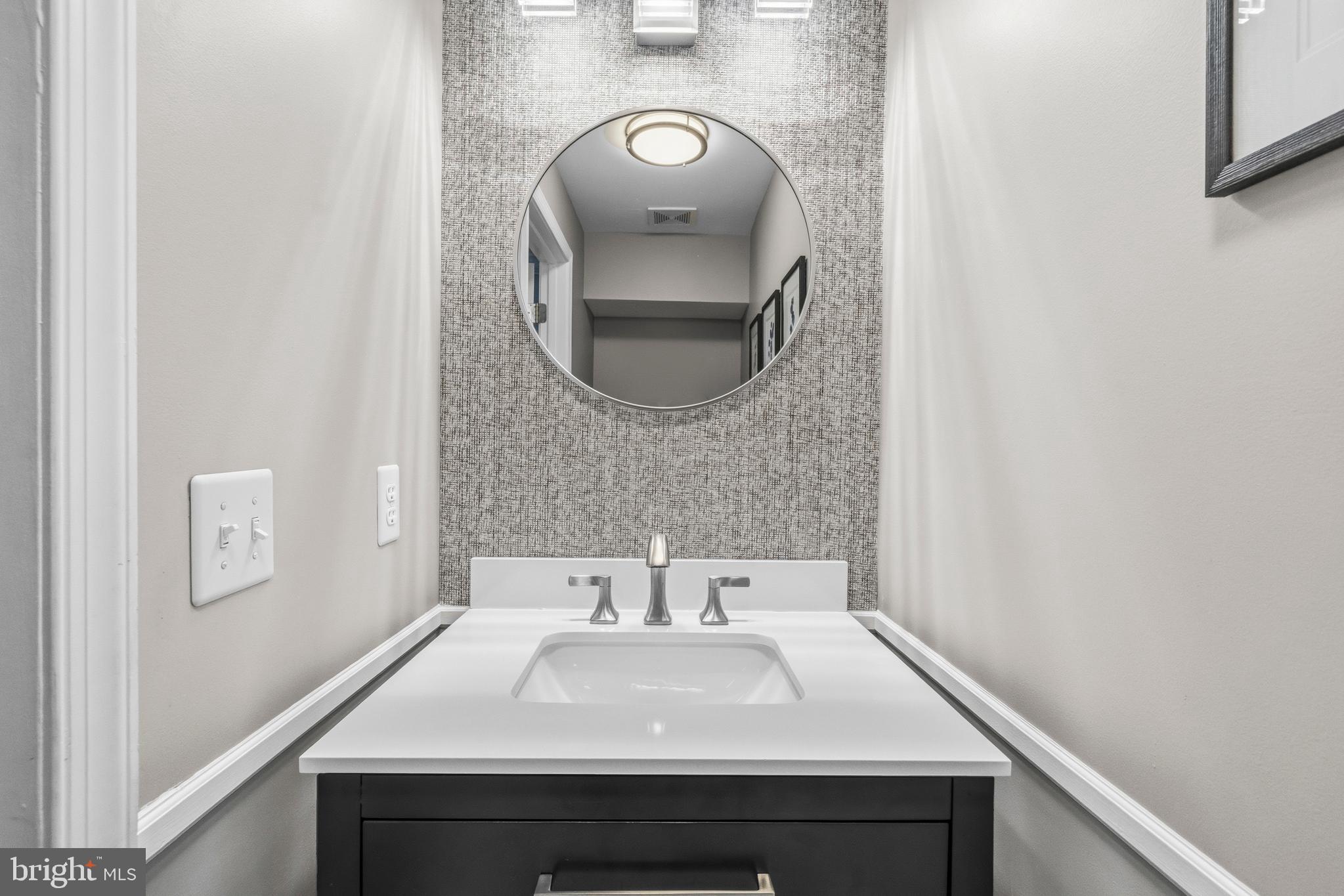 12138 Chancery Station Circle Reston, VA 20190 - Photo 22 of 54 a bathroom with a sink and a mirror