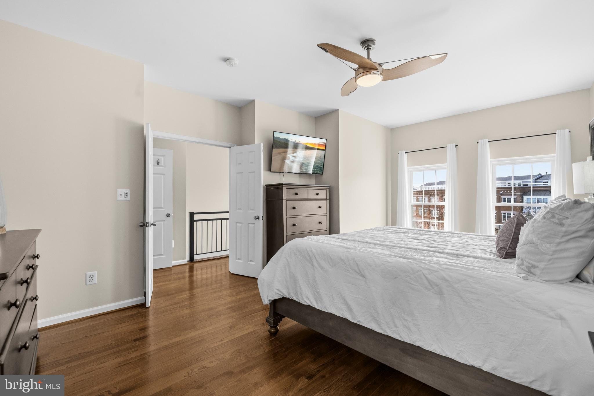 12138 Chancery Station Circle Reston, VA 20190 - Photo 24 of 54 a bedroom with a large bed and a ceiling fan
