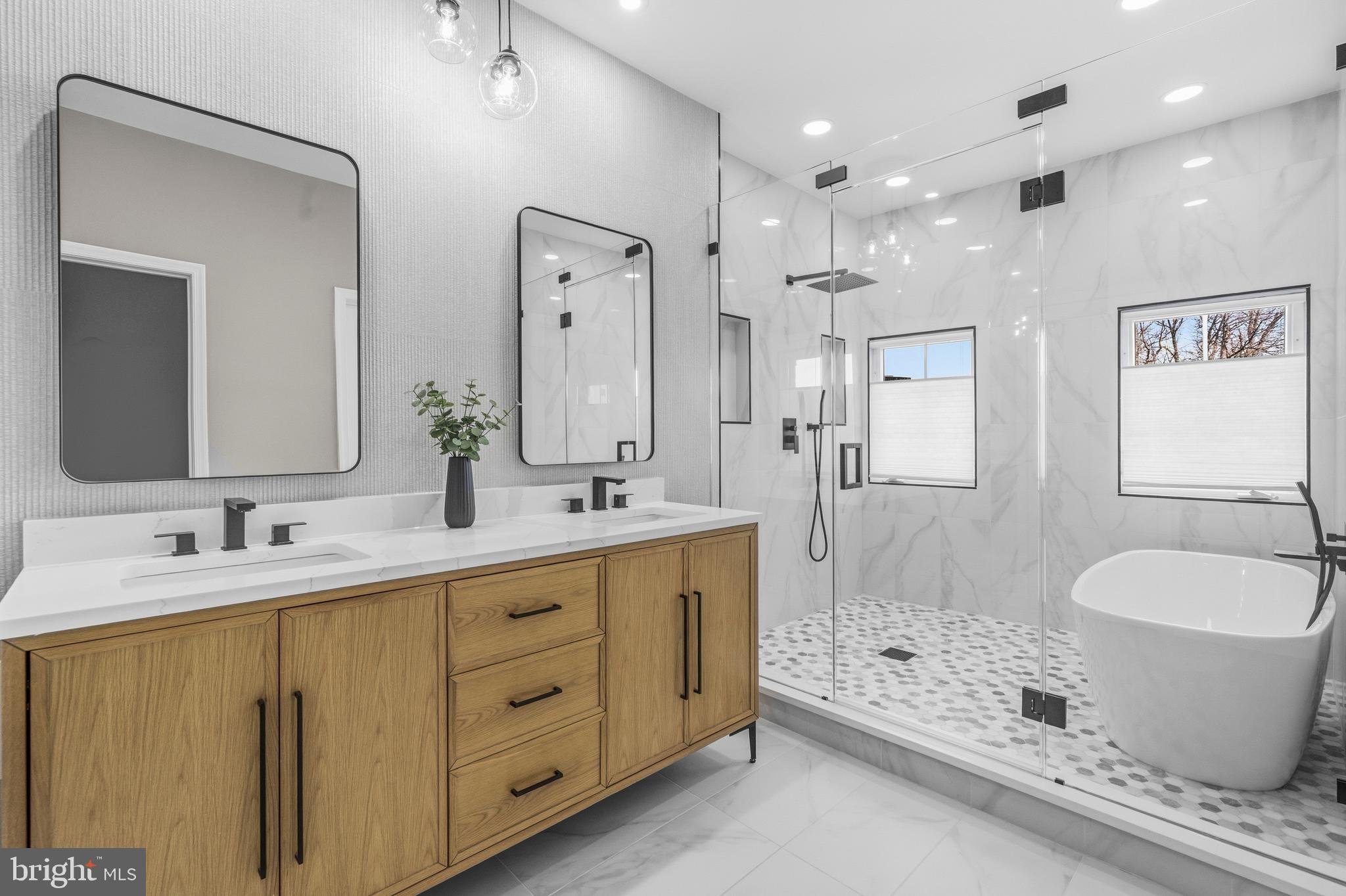 12138 Chancery Station Circle Reston, VA 20190 - Photo 26 of 54 a spacious bathroom with a double vanity sink a mirror a bathtub and shower