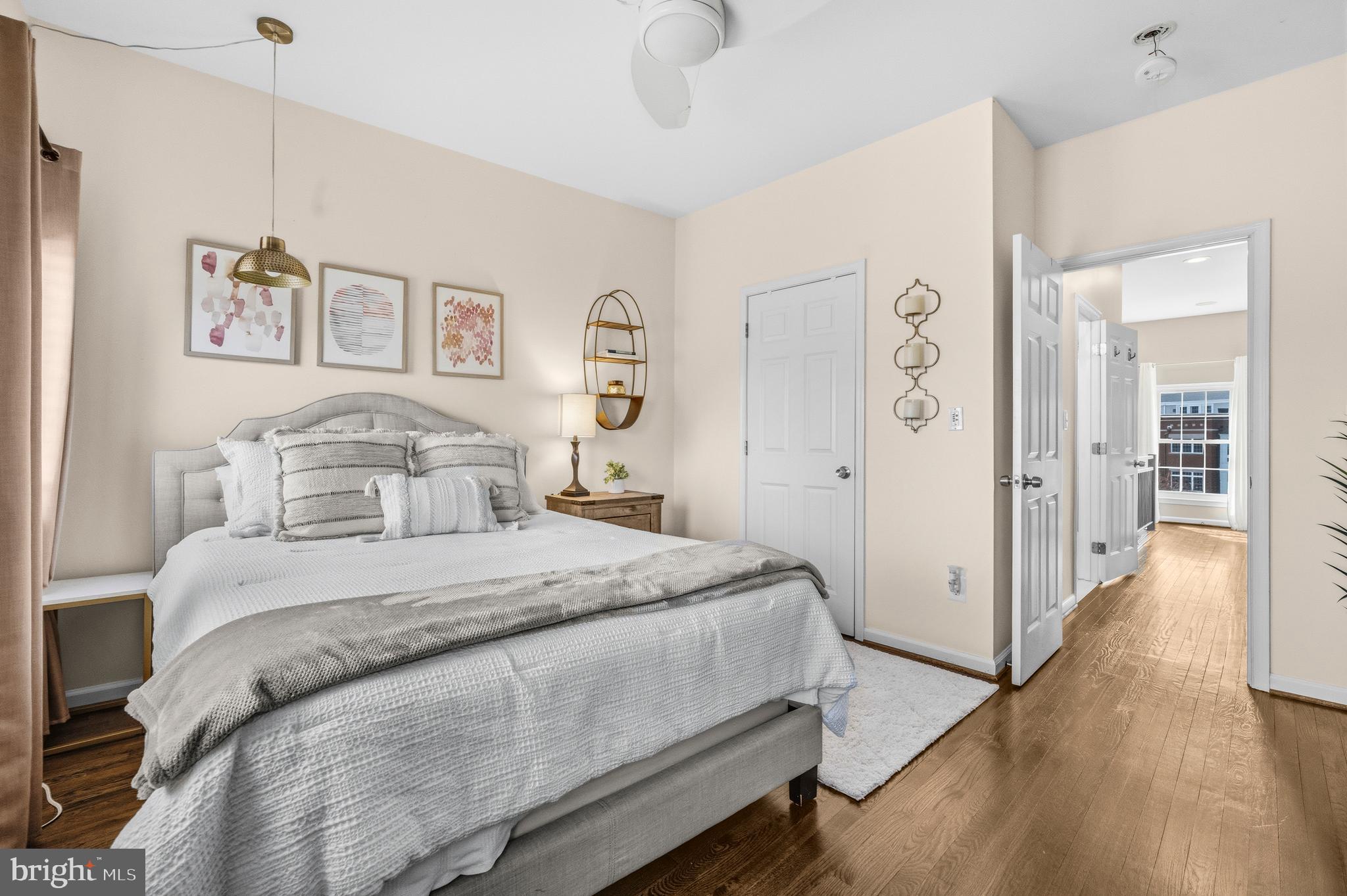 12138 Chancery Station Circle Reston, VA 20190 - Photo 29 of 54 a spacious bedroom with a bed and painting on the wall