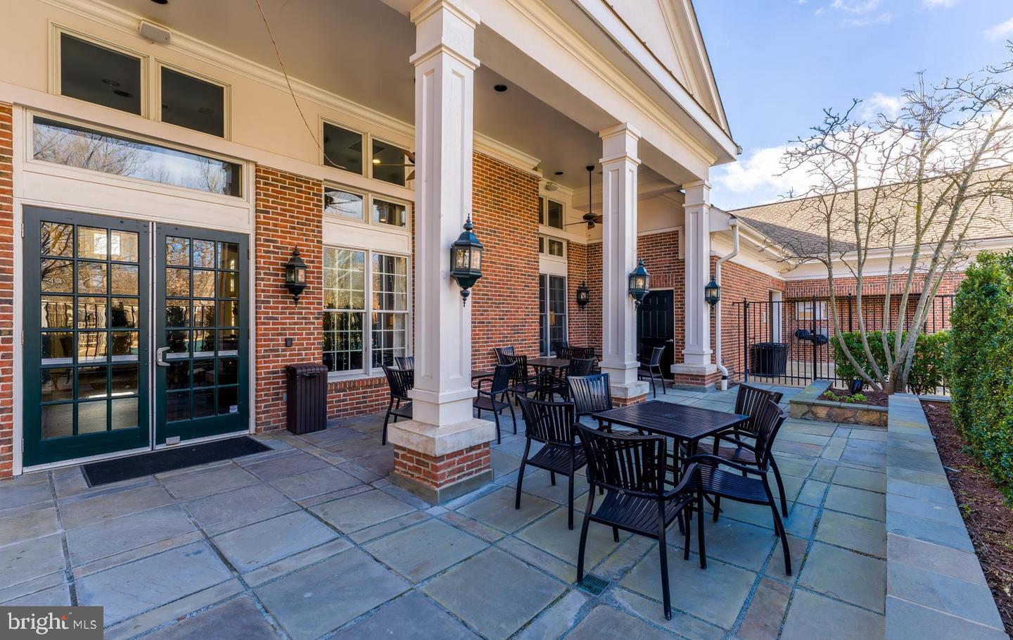 12138 Chancery Station Circle Reston, VA 20190 - Photo 39 of 54 a view of a patio with a table and chairs and floor to ceiling window