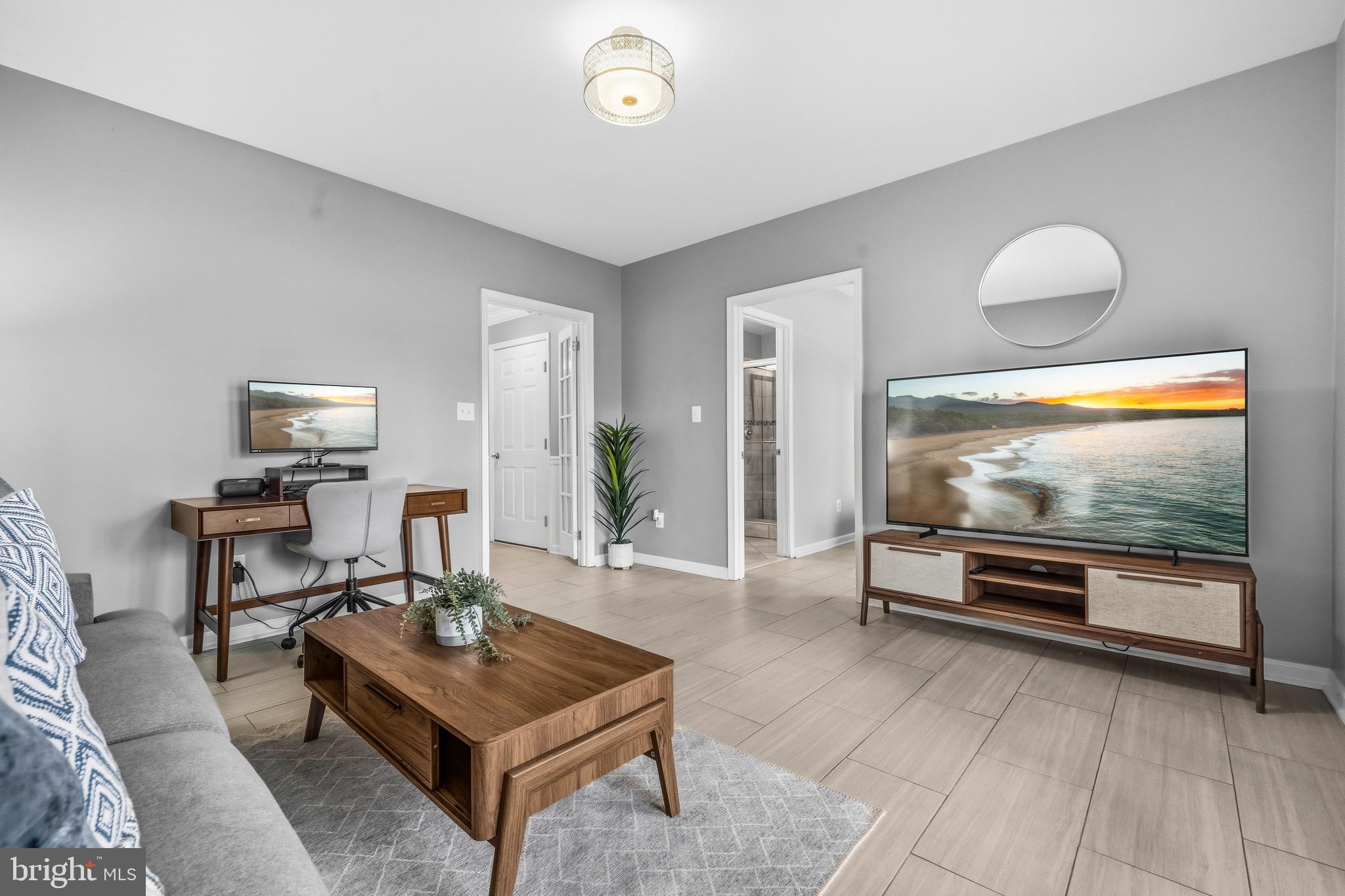 12138 Chancery Station Circle Reston, VA 20190 - Photo 6 of 54 a living room with furniture and a flat screen tv