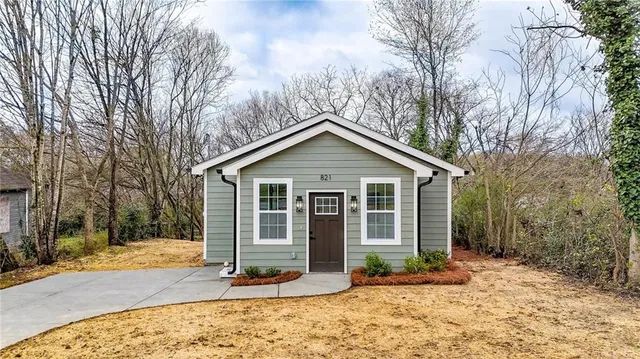 a view of a house with a yard covered in snow