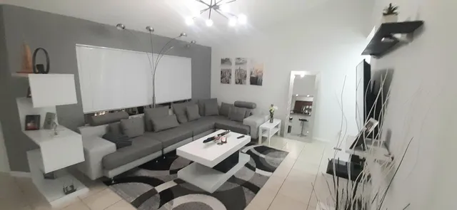 a living room with furniture and a flat screen tv