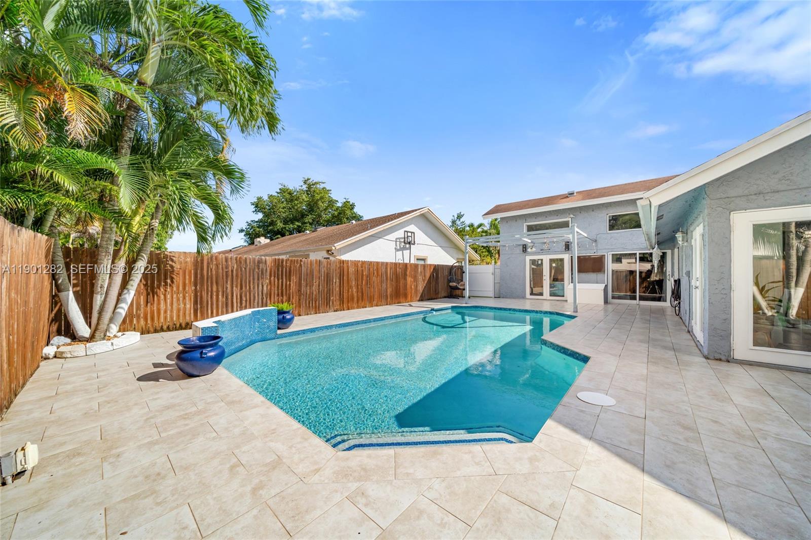 a view of backyard with swimming pool and outdoor seating