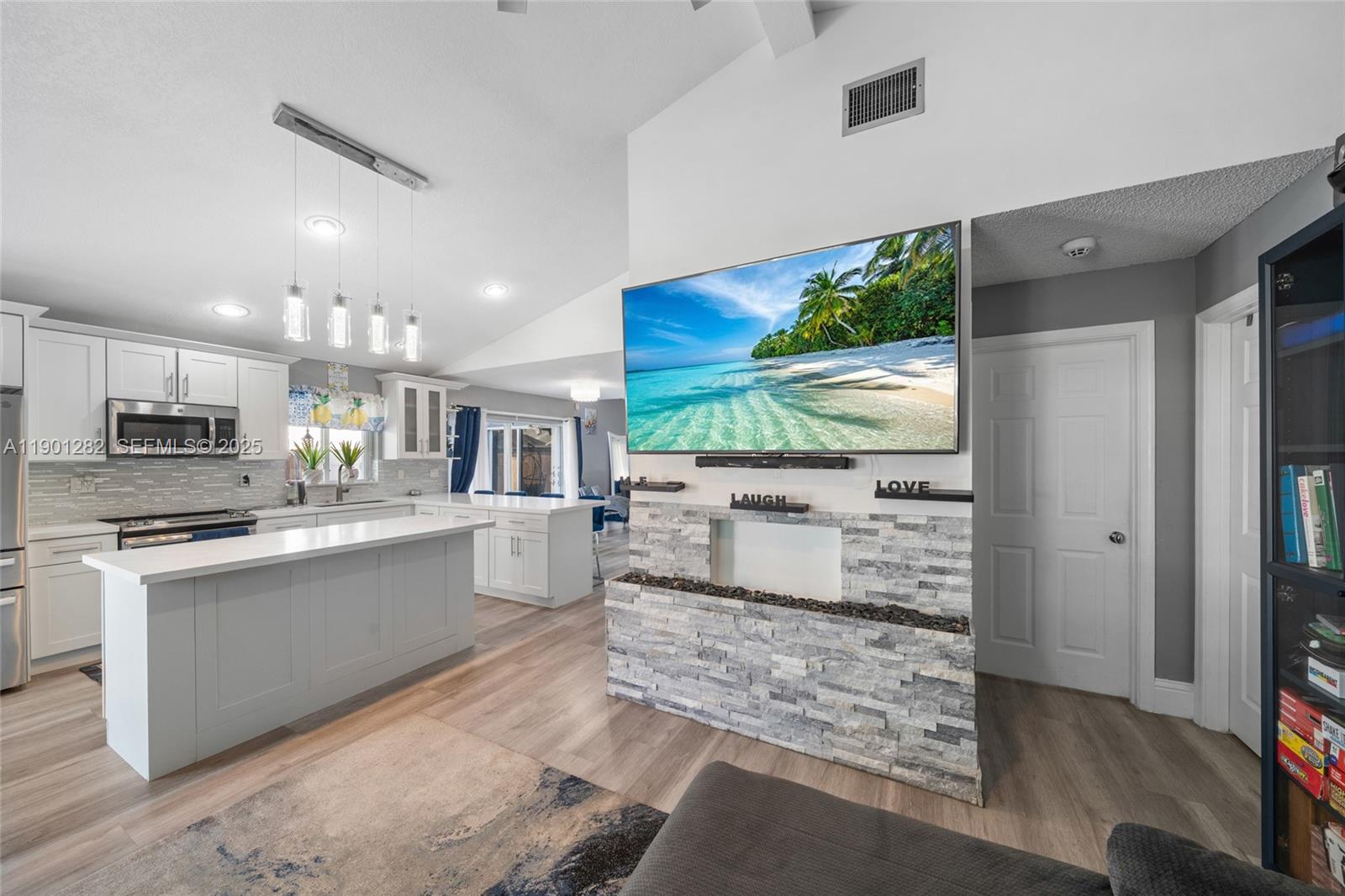 7461 Northwest 36th Street Lauderhill, FL 33319 - Photo 11 of 24 a kitchen with stainless steel appliances kitchen island granite countertop a refrigerator and stove top oven