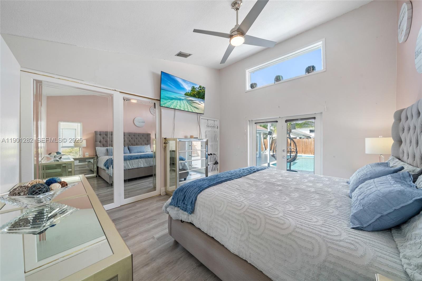 7461 Northwest 36th Street Lauderhill, FL 33319 - Photo 13 of 24 a bedroom with a bed and glass walk in closet