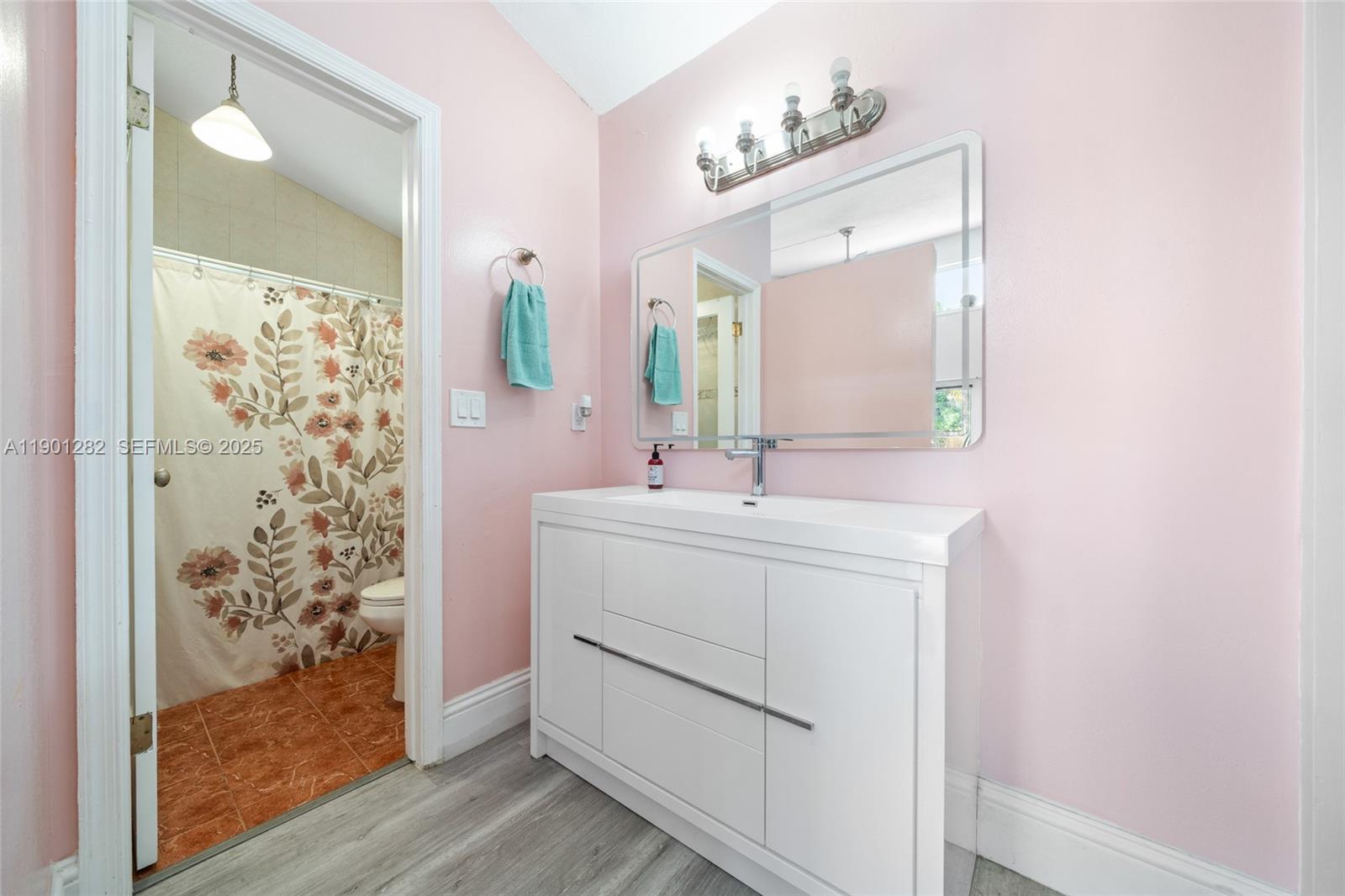 7461 Northwest 36th Street Lauderhill, FL 33319 - Photo 15 of 24 a bathroom with a sink vanity and mirror