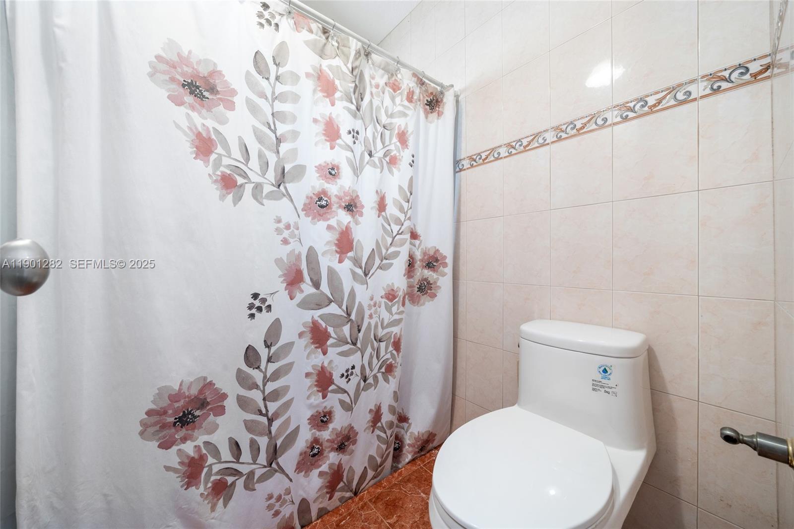 7461 Northwest 36th Street Lauderhill, FL 33319 - Photo 16 of 24 a white toilet sitting next to a shower curtain