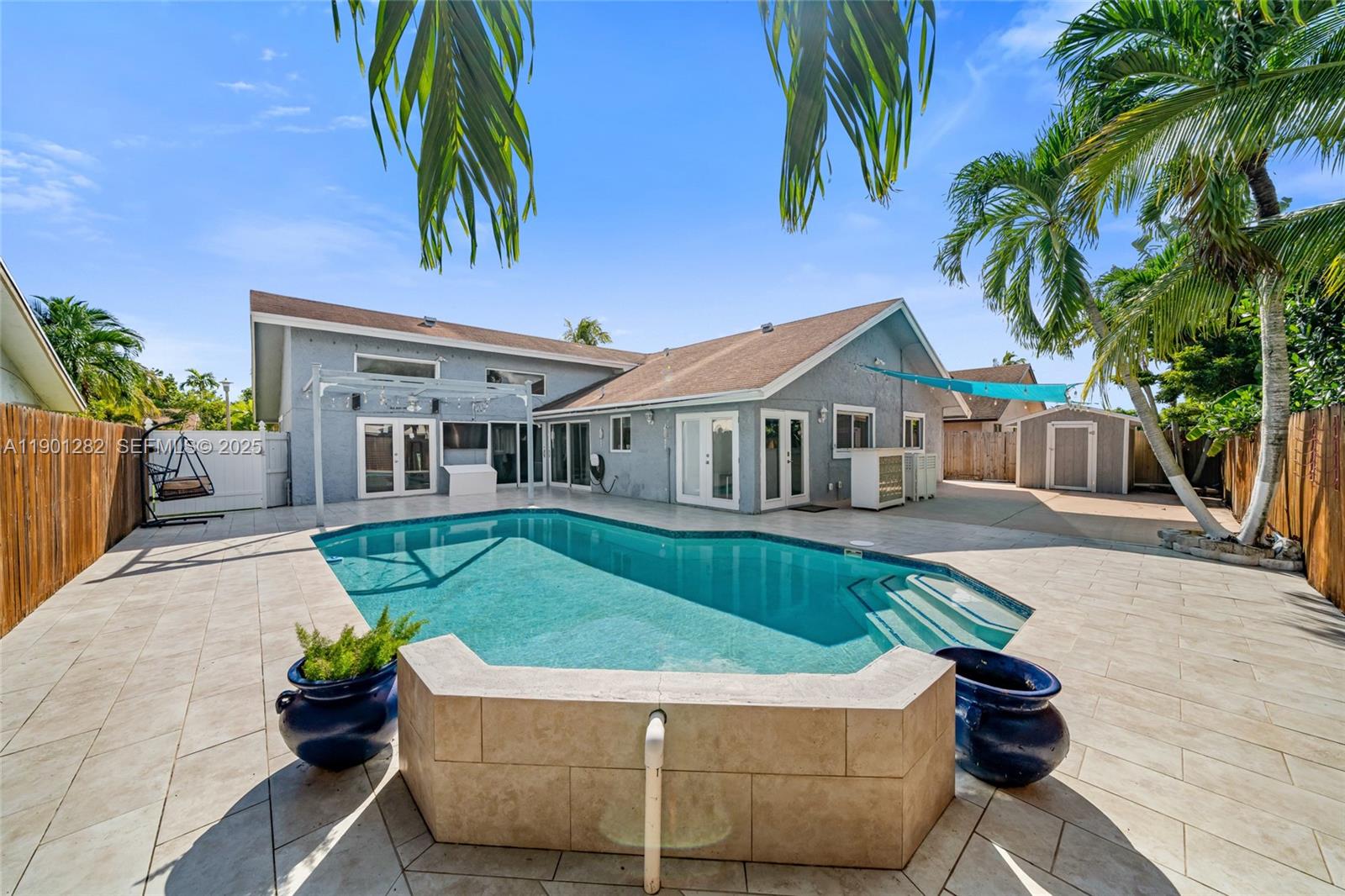 7461 Northwest 36th Street Lauderhill, FL 33319 - Photo 21 of 24 a front view of a house with a garden and patio