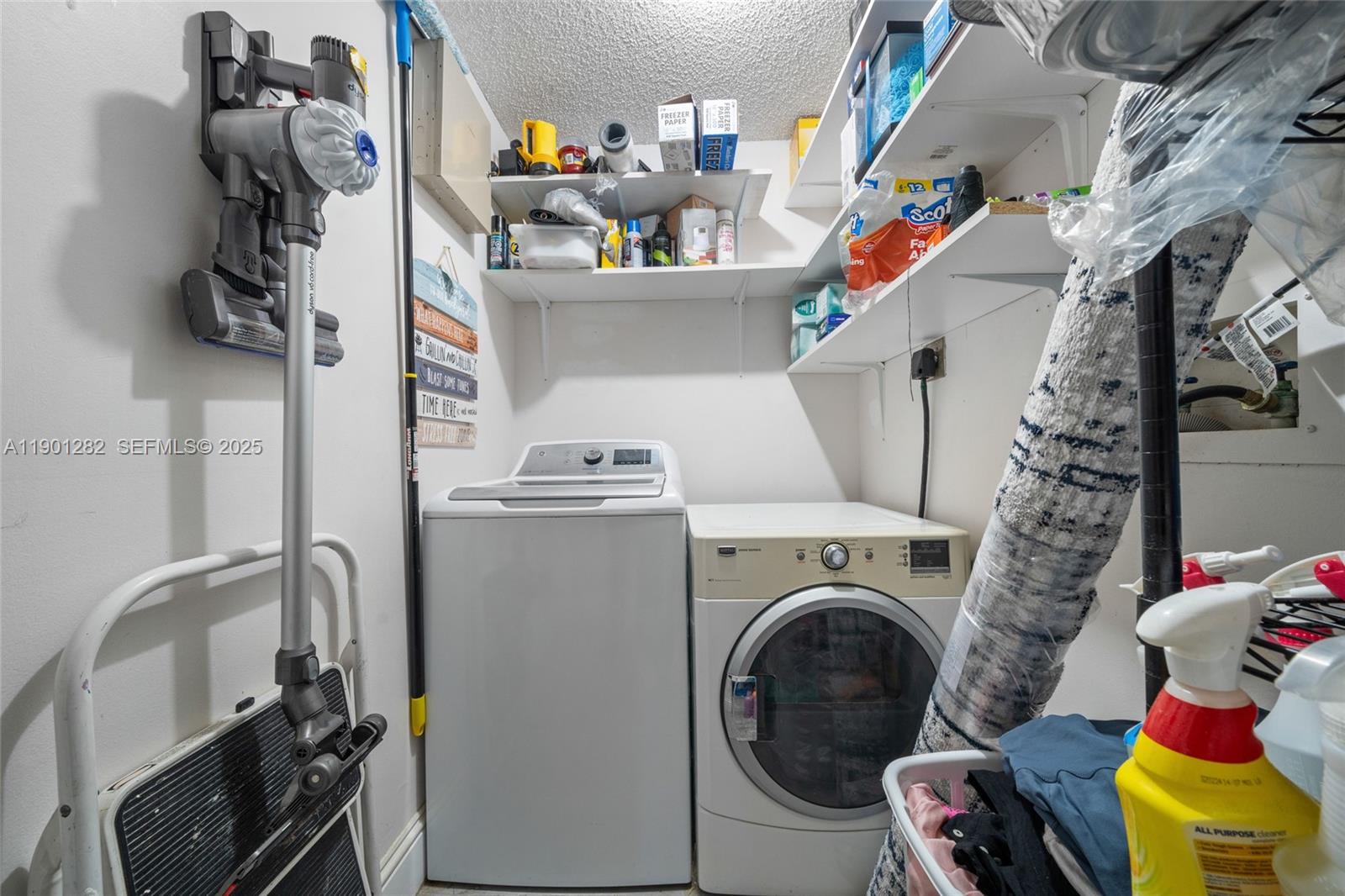 7461 Northwest 36th Street Lauderhill, FL 33319 - Photo 24 of 24 a utility room with dryer washer and a view of living room
