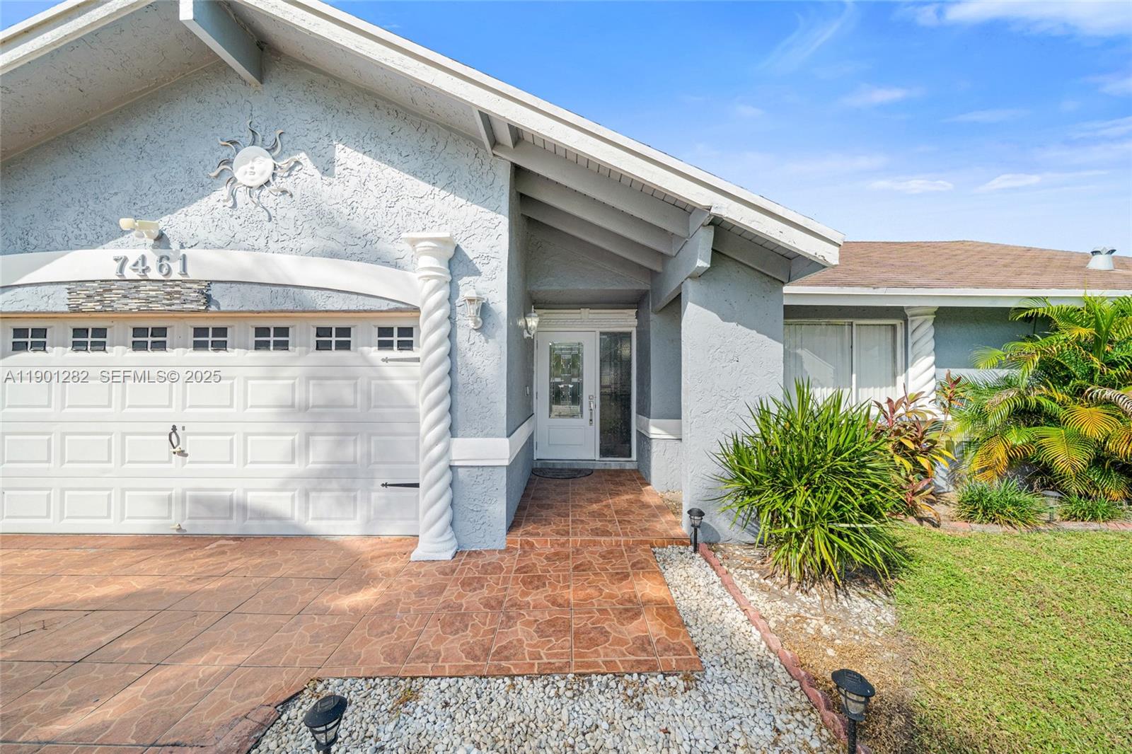 7461 Northwest 36th Street Lauderhill, FL 33319 - Photo 3 of 24 a front view of a house with a yard
