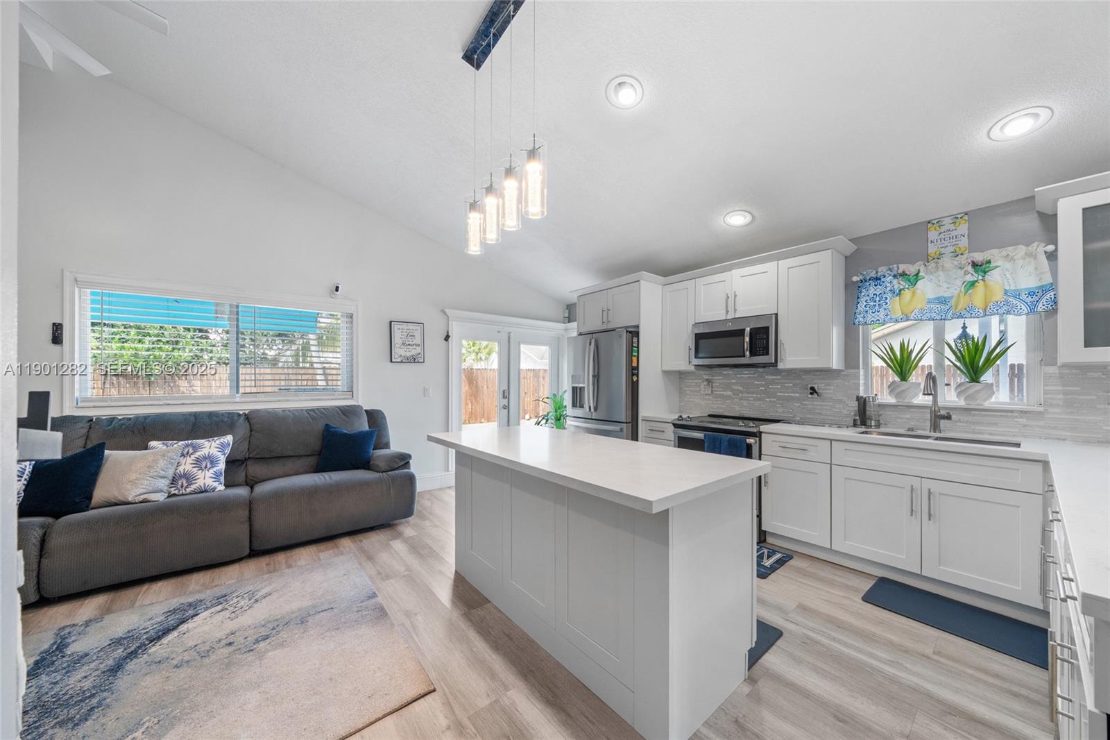 7461 Northwest 36th Street Lauderhill, FL 33319 - Photo 7 of 24 a living room with furniture and a kitchen area