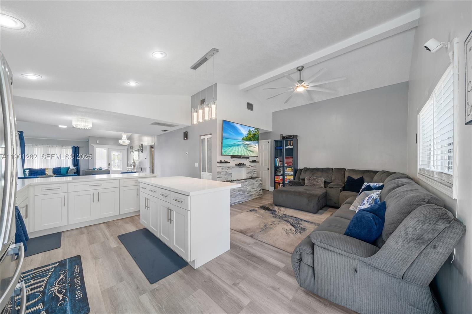 7461 Northwest 36th Street Lauderhill, FL 33319 - Photo 9 of 24 a large white kitchen with a large window a sink and stainless steel appliances
