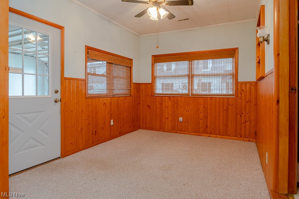 5 Pleasantview Vermilion, OH 44089 - Photo 15 of 37 Unfurnished room featuring light carpet, ceiling fan, and crown molding