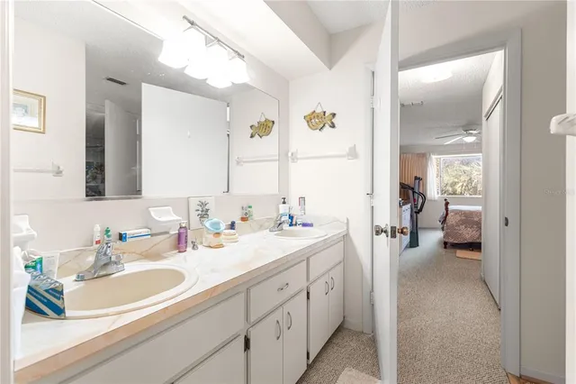 a en suite bathroom with double sink and a mirror