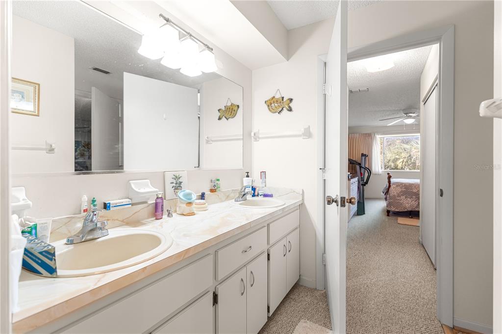 10987 Southwest 86th Terrace Ocala, FL 34481 - Photo 11 of 40 a en suite bathroom with double sink and a mirror