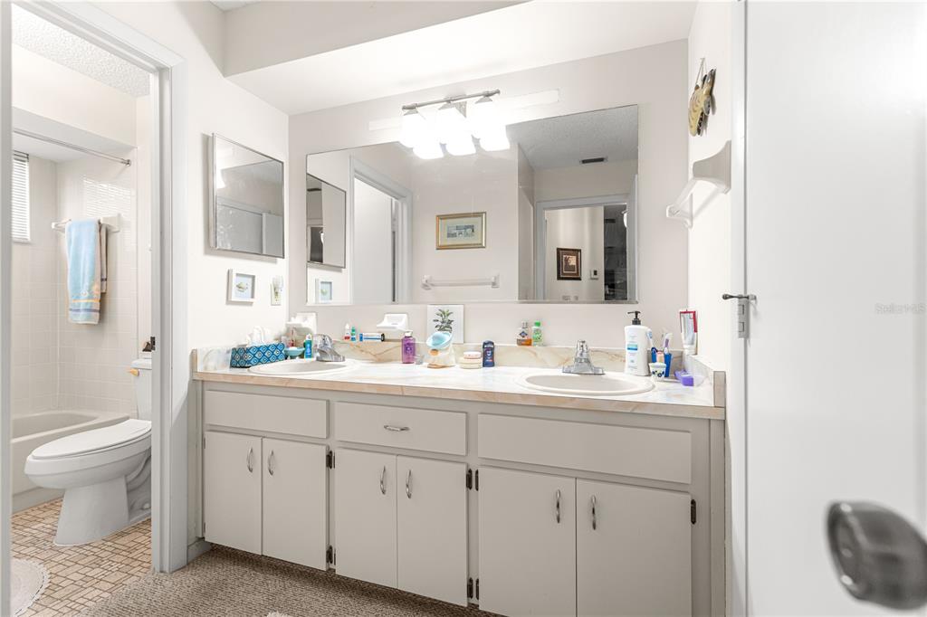 10987 Southwest 86th Terrace Ocala, FL 34481 - Photo 12 of 40 a bathroom with a toilet a sink a and mirror