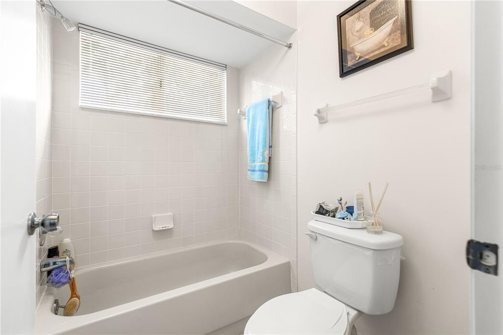 10987 Southwest 86th Terrace Ocala, FL 34481 - Photo 13 of 40 a white toilet sitting next to a bath tub