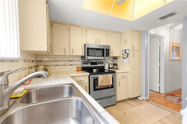 a kitchen with a sink cabinets and stainless steel appliances
