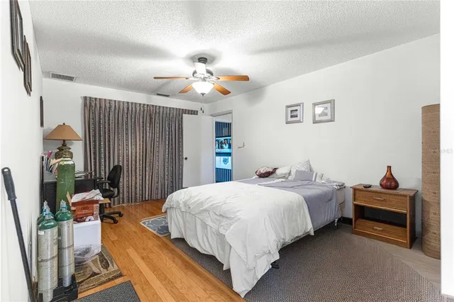 a bedroom with a bed couch and a window