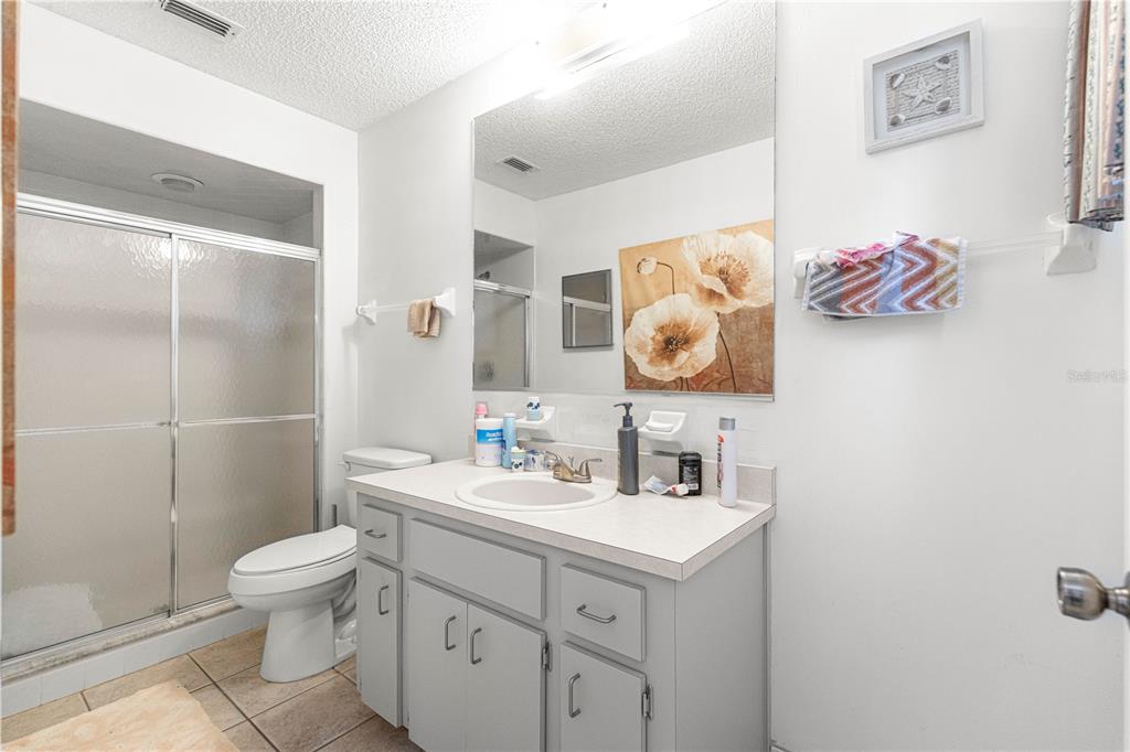 10987 Southwest 86th Terrace Ocala, FL 34481 - Photo 23 of 40 a bathroom with a toilet sink vanity and mirror