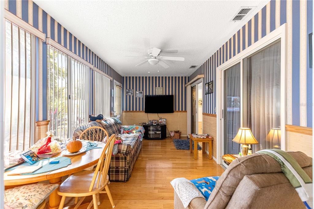10987 Southwest 86th Terrace Ocala, FL 34481 - Photo 27 of 40 a living room with furniture and a flat screen tv