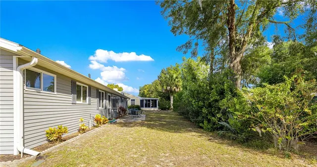 a view of a house with a backyard