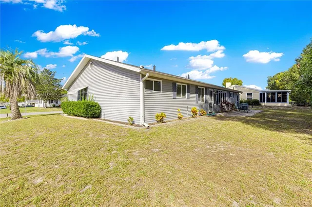a view of a house with yard and swimming pool
