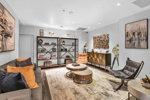 a living room with furniture and a potted plant